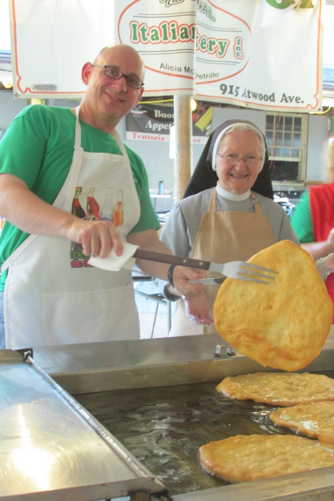 DELIGHTFUL DUTY: Frank Celseti and Sister Mary Antoinette were among the many people who kept cooking all kinds of doughboys &ndash; which just so happens to be the most popular treat at the saint Rocco Fest and Festival.