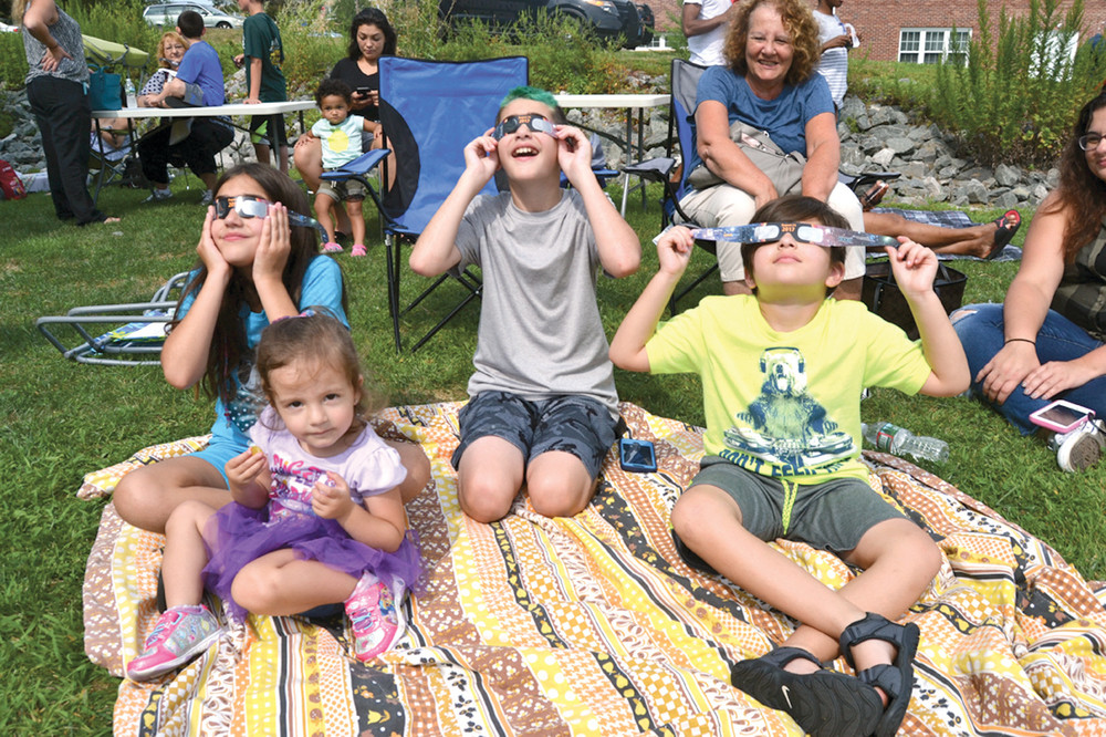 TOMORROW&rsquo;S ASTRONOMERS: Dozens of children, including those seen here, celebrated this year&rsquo;s solar eclipse with a wide array of activities planned by the staff and volunteers at the Marian J. Mohr Library on Monday.