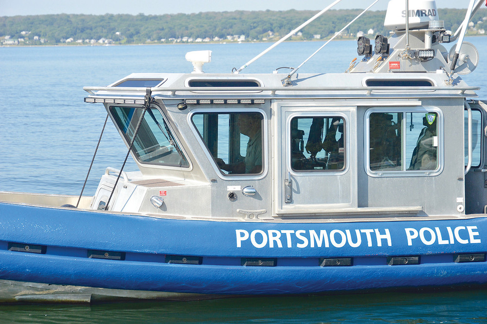 A camera-shy Stephen Burns, Portsmouth harbormaster, returns the police boat back to the Carnegie Abbey dock recently.