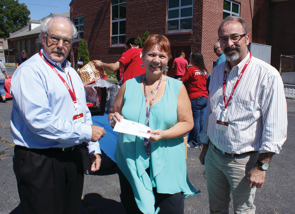 DONATION: On Sept. 1, TJ Maxx took on a large project collecting school supplies for the Family Center/COZ. On that day, TJ Maxx also donated a check for $1,100. Pictured are (l-r) Mike McGrath (district manager for TJ Maxx), Robin Gervais (Co-Coordinator of the Family Center/Coz) and Carlos Laires (Manager of the Cranston TJ Maxx).