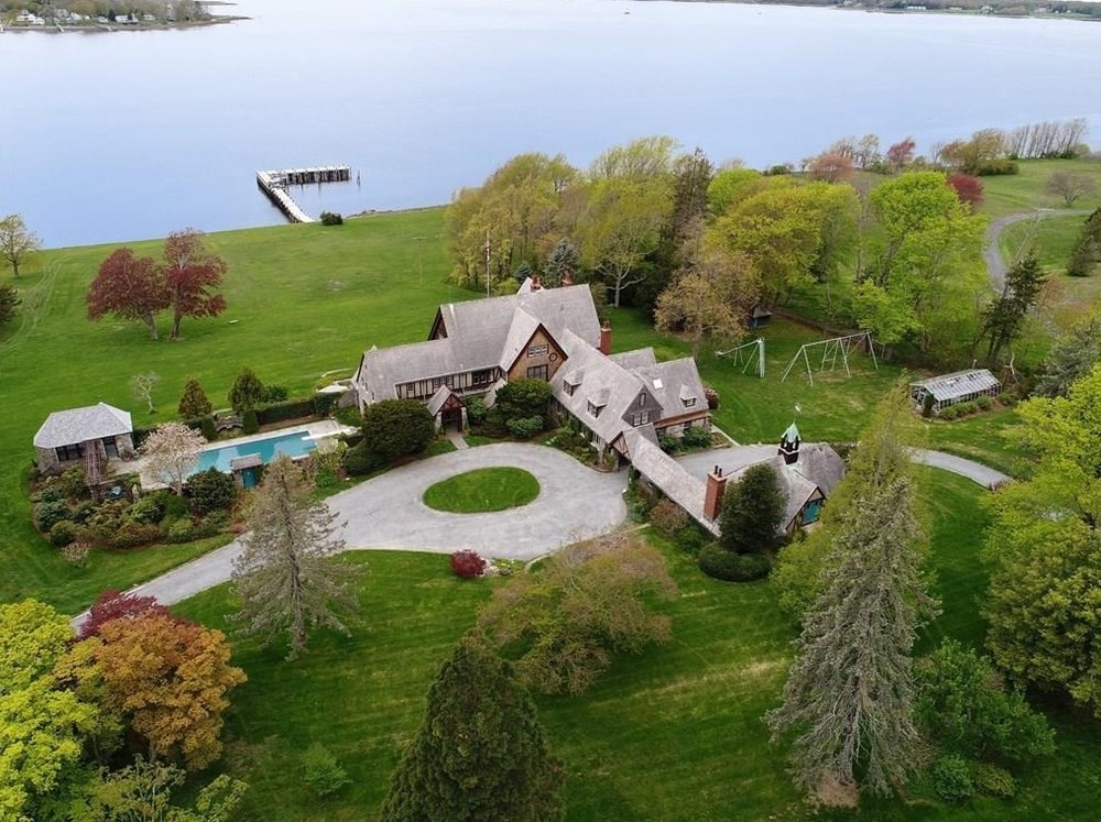 The &quot;Wind Hill&quot; estate includes multiple buildings, a deep-water dock facing Narragansett Bay, tennis courts, 13 garage spaces, stables and a pool.