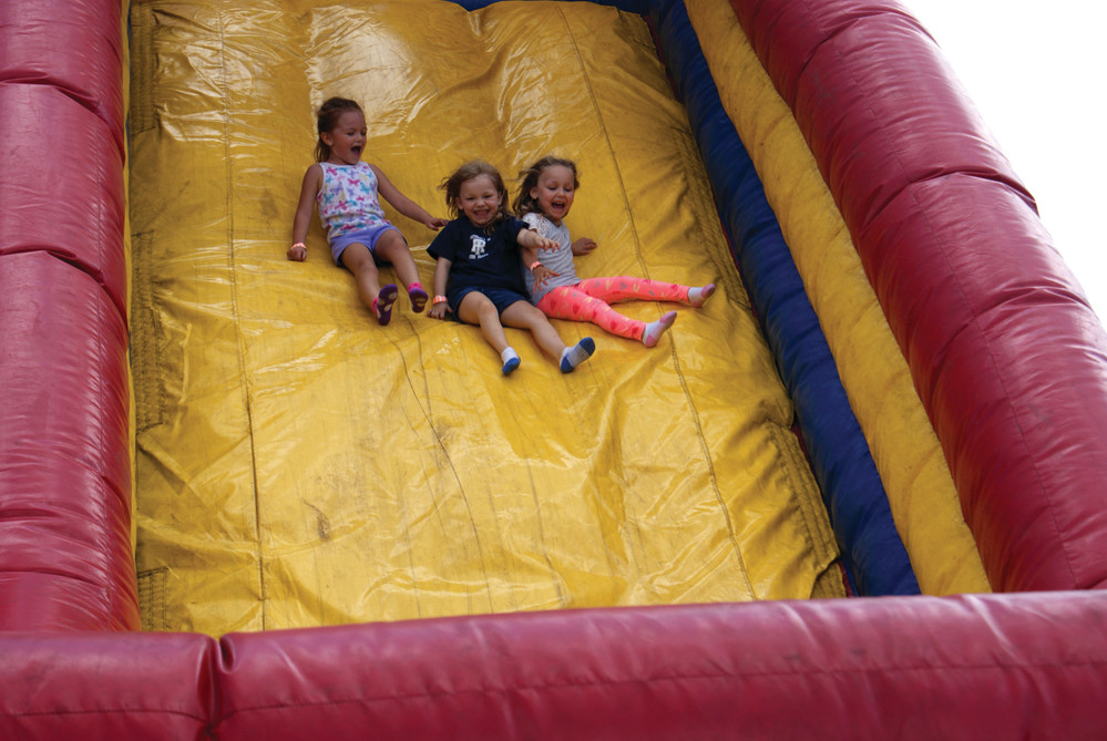 SLIP SLIDING AWAY: Pictured on the Giant Slide at the Confreda Fall Festival were Siena Ross, age 4 along with twins Madelina and Angie Kennedy, age 4.