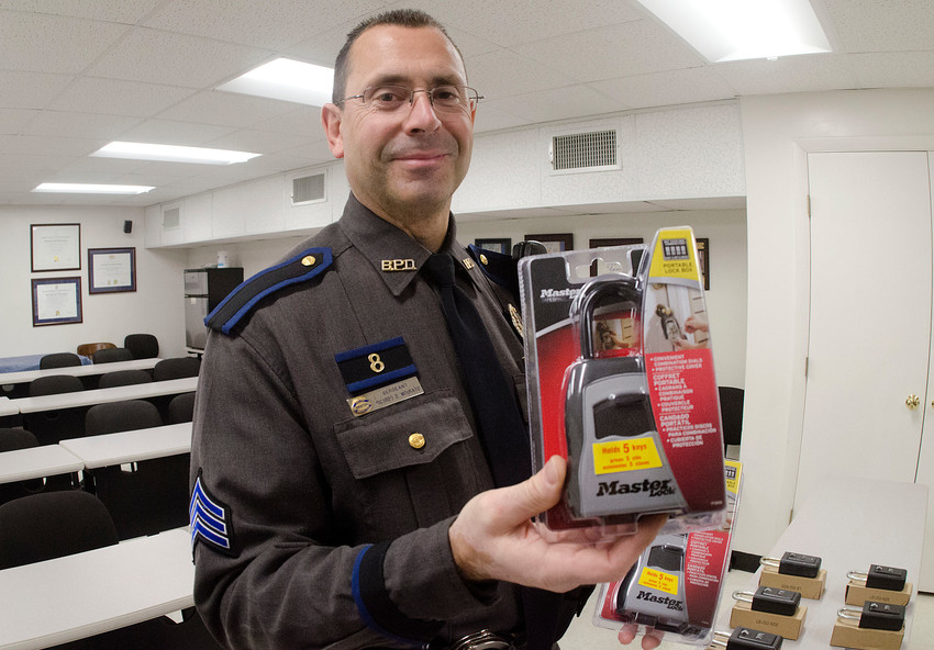 Bristol Police Sergeant Ricardo Mourato holds up a real estate lockbox.