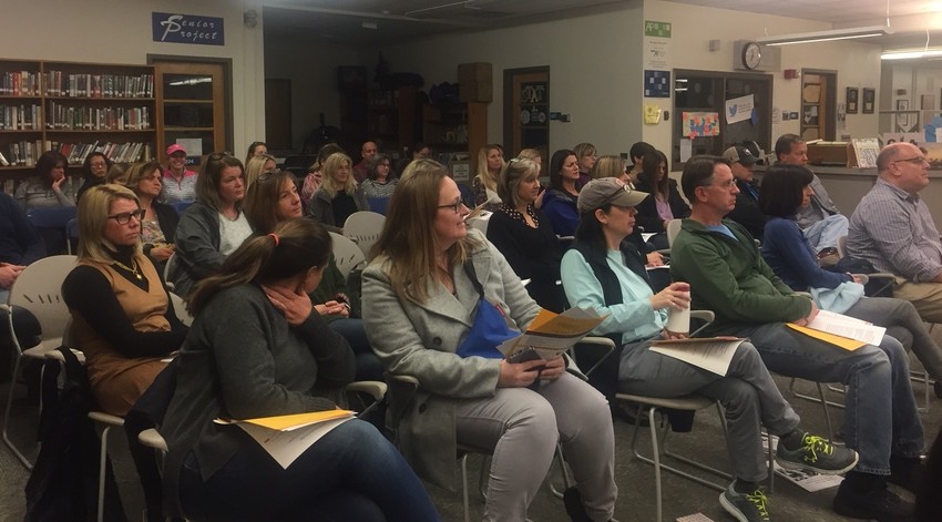 Parents of Barrington High School students listen to officials discuss the vaping problem at the school. Many parents at the meeting said their children do not feel comfortable using the bathrooms because other students are vaping there.