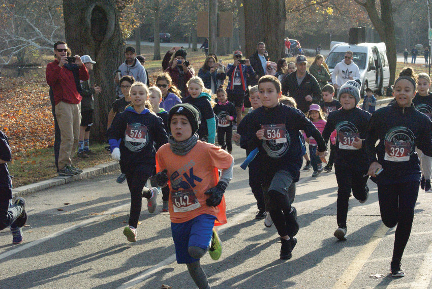 RUN OF HONOR: Park View Middle School hosted its seventh annual Veterans Day 5K event at Roger Williams Park on Monday. Above, Logan Seals of Johnston and other participants are seen at the start line for the 1-Mile Kids Fun Run. Seals went on to win the race with a time of 6 minutes, 27 seconds. For full coverage, turn to Page 6.