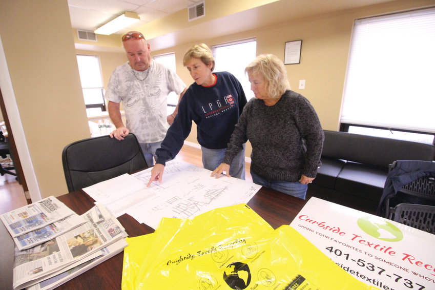 WARWICK IN THEIR SIGHTS: Don Mariani, Marjorie Muller and Melanie Flamand, the principals in Curbside Textile Recycling, look over route maps for Warwick.