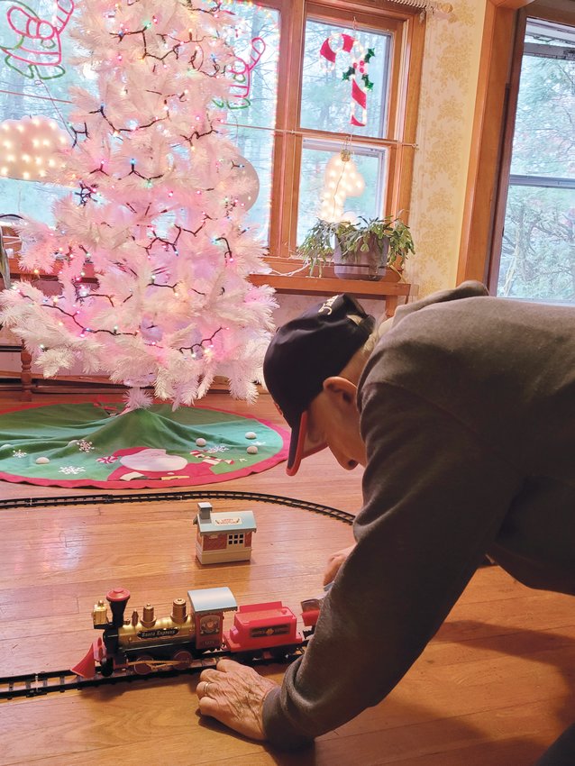 I THINK I CAN: Bernie Pavia kneels down to play with his trainset in his newly remodeled living room. The Korean War veteran&rsquo;s Johnston home was nearly totaled when a tree fell on it last Christmas. A small group of dedicated workers helped salvage the house, and Pavia&rsquo;s spirit.