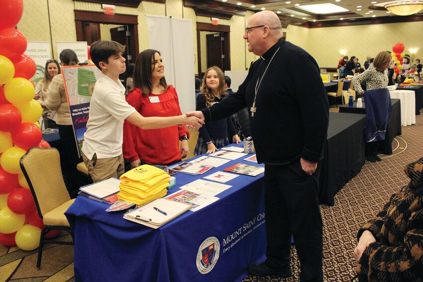 Bishop Richard G. Henning greets students, parents, teachers and administrators from local schools gathered  in the ballroom at the Crowne Plaza to partake in the School Choice Fair.