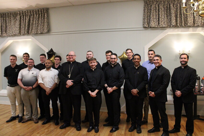 Seminarians gathered with their families, local clergy and members of the diocesan chapter of The Serra Club to honor the role of their families and parents in their priestly formation. Above, seminarians and priests join Bishop Richard G. Henning for a photo.