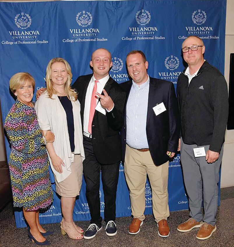 Pioneer in Education: Martha Murray, who helped to establish the Options Program at Bishop Hendricken, gathers with the family of Stephen Baker, the first Hendricken student in the program to graduate from a Catholic college or university, on the occasion of his graduation from Villanova University. With Martha are mother Kerri Baker, Stephen, Philip Murray, and father Steve Baker.