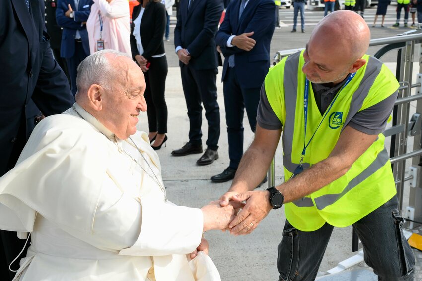 Pope Francis, seated in a wheelchair, is lifted aboard his overnight flight from Rome’s Fiumicino airport to Jakarta, Indonesia, Sept. 2, 2024. This marks the start of his 45th international trip, the longest of his papacy.