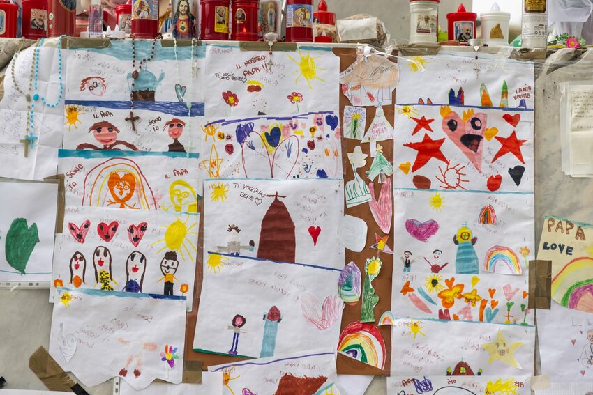 Well Wishes: Drawings for Pope Francis cover the base of a statue of St. John Paul II outside Rome’s Gemelli hospital March 8, 2025.