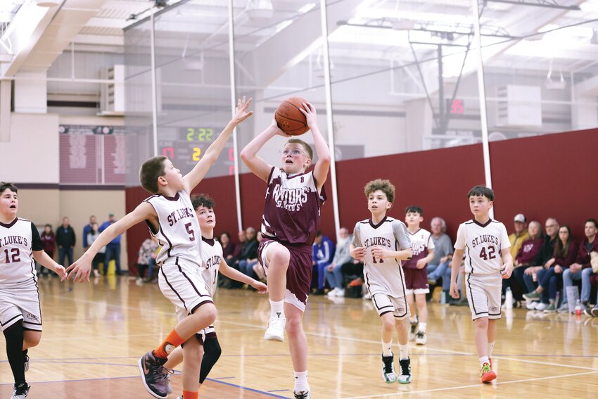 Gathered in the La Salle Academy gymnasium, St. Rocco School of Johnston take on St. Luke’s School, Barrington.