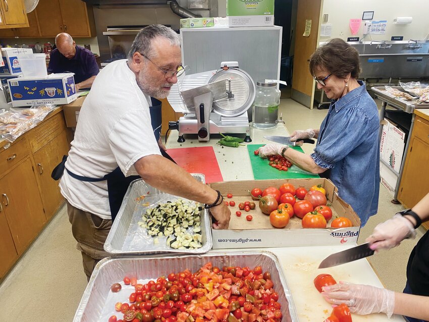 Sous chef volunteers John Romano and Emily Henault use the freshest ingredients to prepare healthy meals for those in need through the Kitchen of Hope Program, based at St. Francis of Assisi Parish in Wakefield. Among the guests served by the ministry are many elderly people in their 80s and 90s.