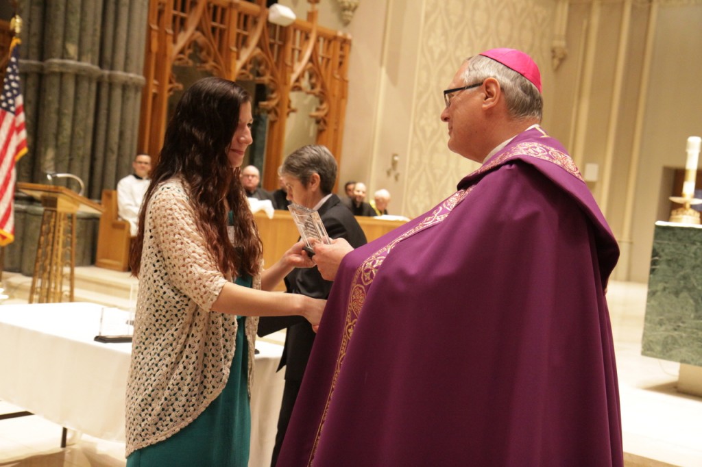 Emily Cuellar, a freshman studying psychology and religious studies at Salve Regina University, receives from Bishop Thomas J. Tobin the St. Timothy Award in recognition of her service inspiring young people to follow their faith at the Rejoice in Hope Youth Center. &quot;Emily is on fire with her faith. She is a dedicated follower and servant of Jesus, giving witness to her faith and her love for God in all she does,&quot; her nominator for the award wrote of Emily. Other winners in the category were Daniel Arteaga, Kyle Aubin, Thomas Desmarais, Lauren King, Aaron O?Brien Mackisey, Jordan Robitaille, Kara Tracy, Ashley van Orsouw and David Zuleta.