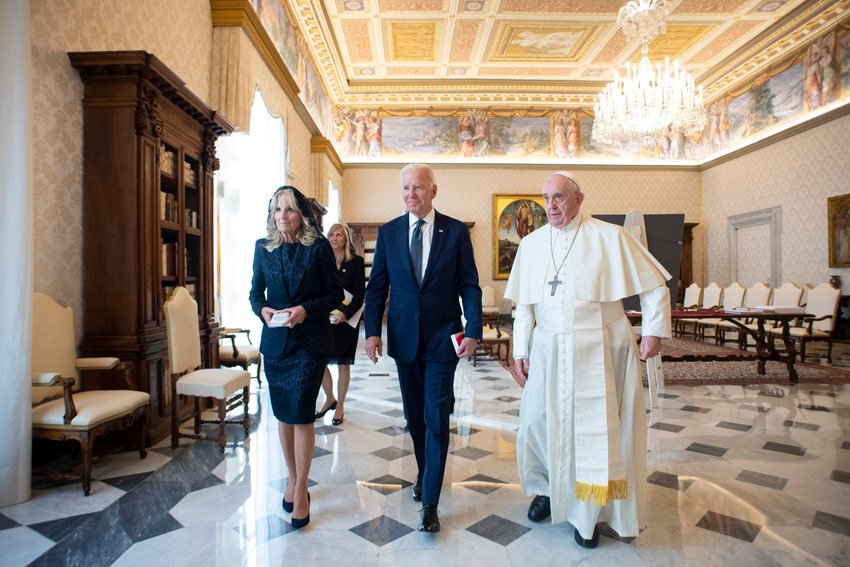 U.S. President Joe Biden, accompanied by his wife, Jill, is walks with Pope Francis during a meeting at the Vatican Oct. 29, 2021.