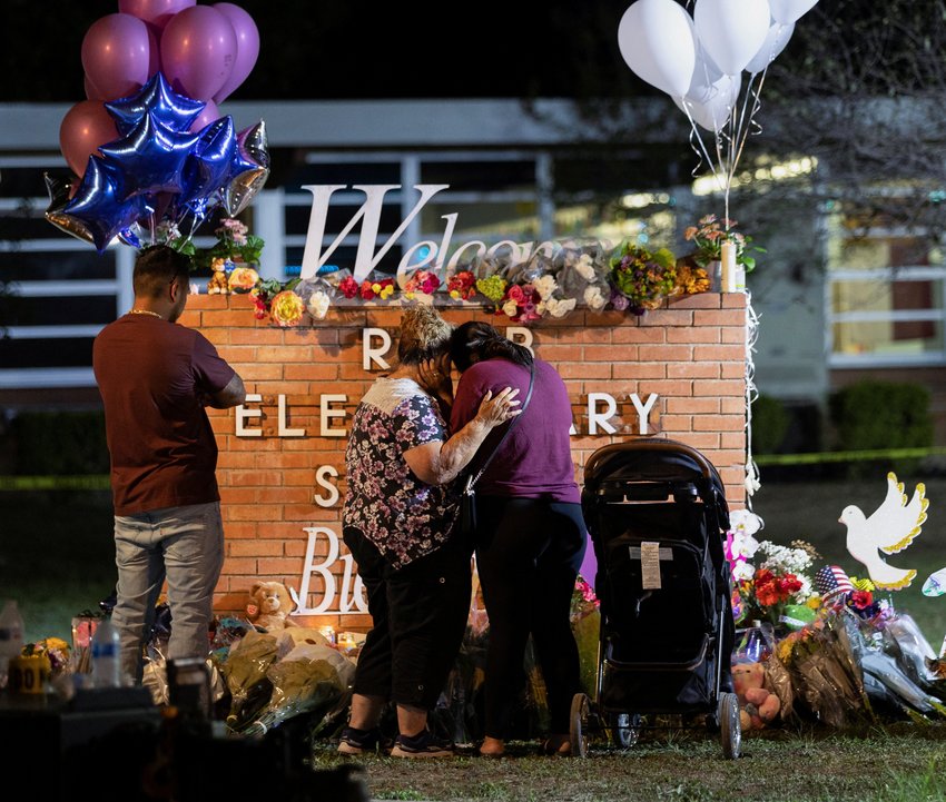 People visit a memorial outside Robb Elementary School in Uvalde, Texas, May 25, 2022, the site of a mass shooting.