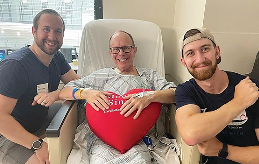 In this photo from Father Henry Zinno&rsquo;s Instagram account, the pastor of Our Lady of Mount Carmel in Bristol holds up a stuffed heart in the cardiac unit of Mount Sinai Hospital. He is joined by his nephews, Kevin and Danny.