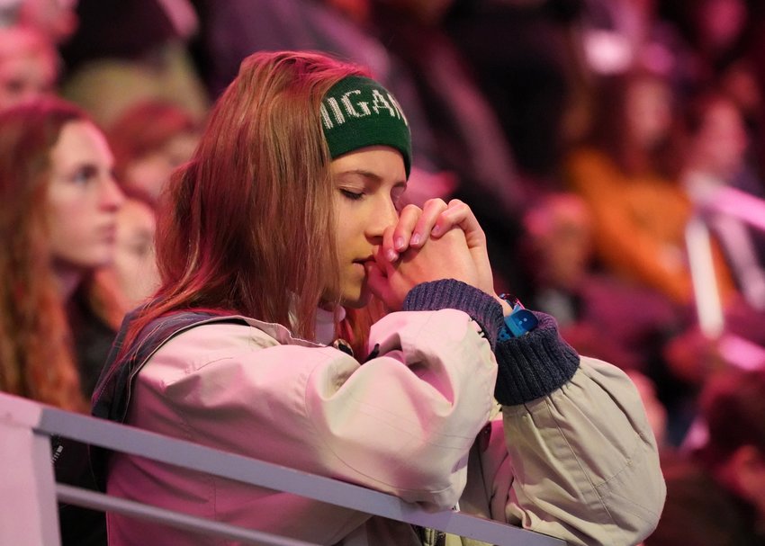 A teenager prays during a pro-life youth Mass at Capital One Arena in Washington.