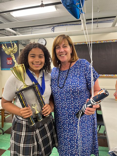 Sixth-grader Amani Migwi won first place for Rhode Island in SIFMA Foundation&rsquo;s Spring 2022 National InvestWrite Competition. Migwi is pictured here with St. Margaret School principal Lee Ann Nunes.