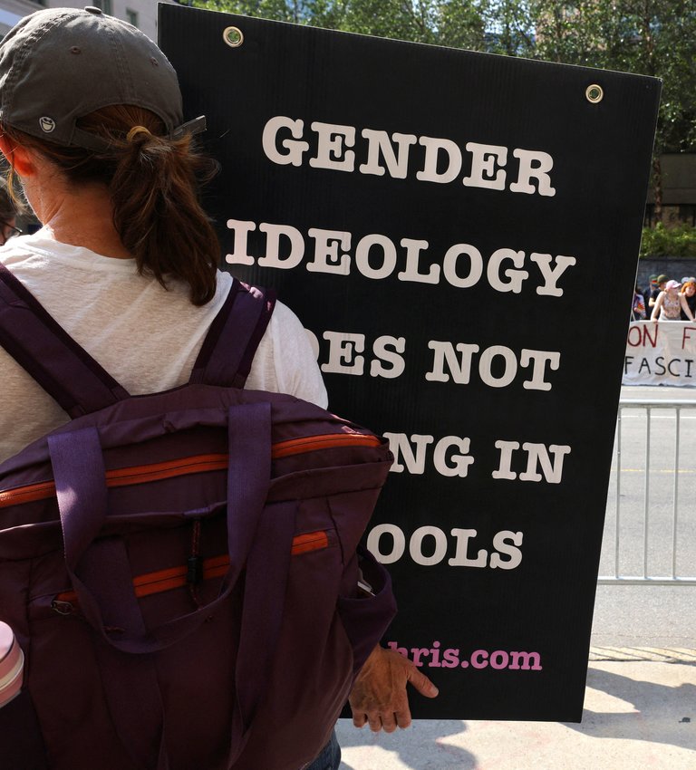 A supporter who opposes medical treatments for transgender youth, stands across the street from counter-protestors outside Children's Hospital in Boston Sept. 18, 2022. The U.S. bishops' doctrine committee says surgery, and medical intervention to change person's &quot;sex characteristics&quot; to those of opposite sex &quot;are not morally justified.&quot;