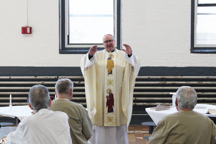 Bishop Richard G. Henning celebrates Mass on Easter Sunday for 24 inmates at the Rhode Island Adult Correctional Institute, Cranston.