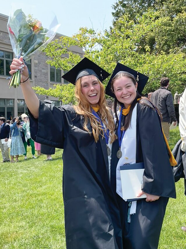 Talia Asvestas and Grace Pelletier celebrate on the lawn after the ceremony on Sunday, May 21, 2023.