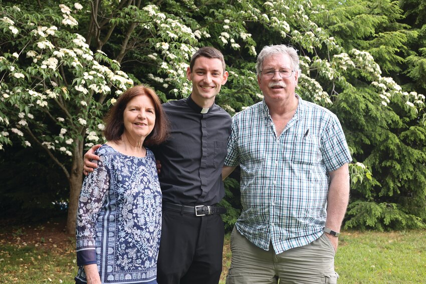 Rev. Mr. Patrick Ryan smiles with his parents Anne and Doug at their family home in Coventry.      On Saturday, June 24, at 10 a.m., Bishop Richard G. Henning will celebrate Holy Mass with the ordination of Deacon Ryan to the Sacred Priesthood. If unable to attend Mass, you may watch the livestream on the Diocese of Providence YouTube channel, www.provd.io/youtube.