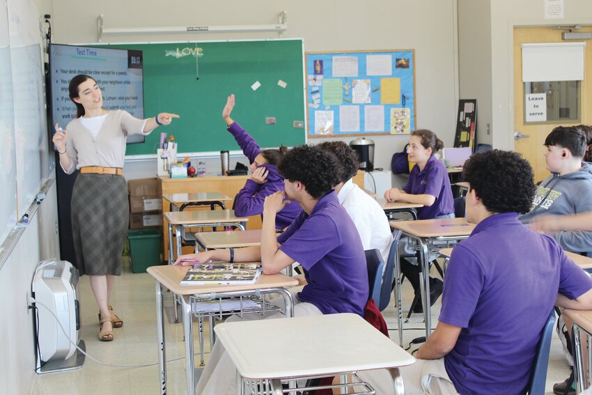 Viola Lohsen, a graduate of the Catholic Universty of America, teaches a group of her students at St. Raphael Academy during a year of service while earning her master&rsquo;s degree at Providence College as part of the PACT program.