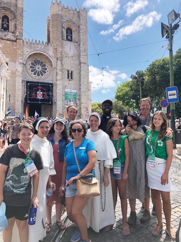 The Providence delegation In Old Lisbon with Father Joseph Brice, Sisters Josemaria and Sophia, Deacon Timothy Flanigan, M.D., Dr. Matthew Cuddeback and family, Maria, the tour guide, and P.C. student teacher Deisy Estrada.