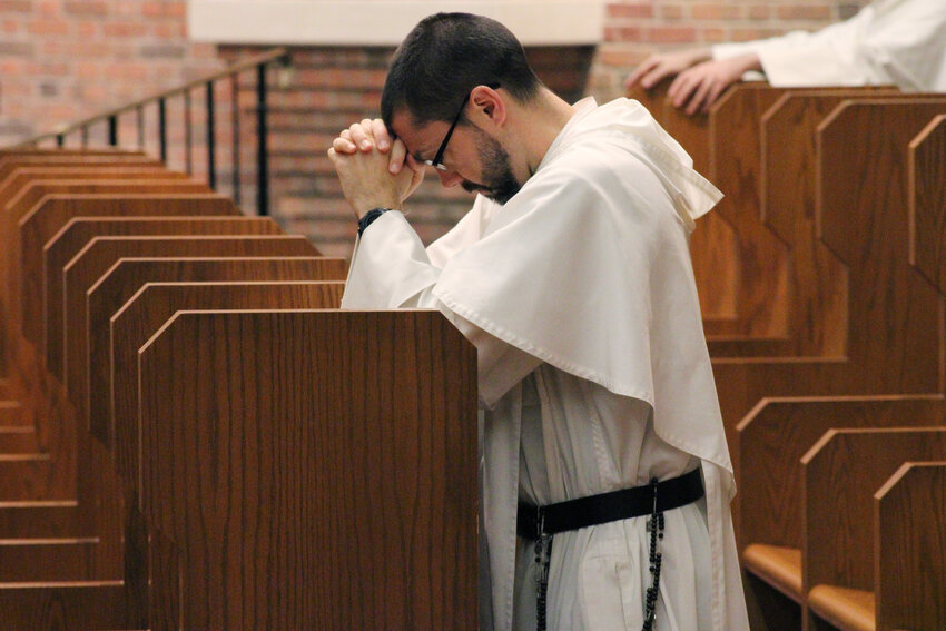 A Dominican friar takes time in prayer on the Providence College campus. The friars founded Providence College in 1917.