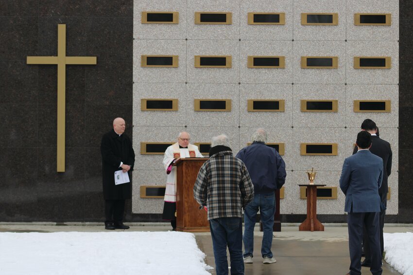 Reverend Msgr. Raymond B. Bastia and Father William J. Ledoux lead a dedication service for the Mausoleum of the Holy Cross at St. Ann&rsquo;s Cemetery, Cranston.