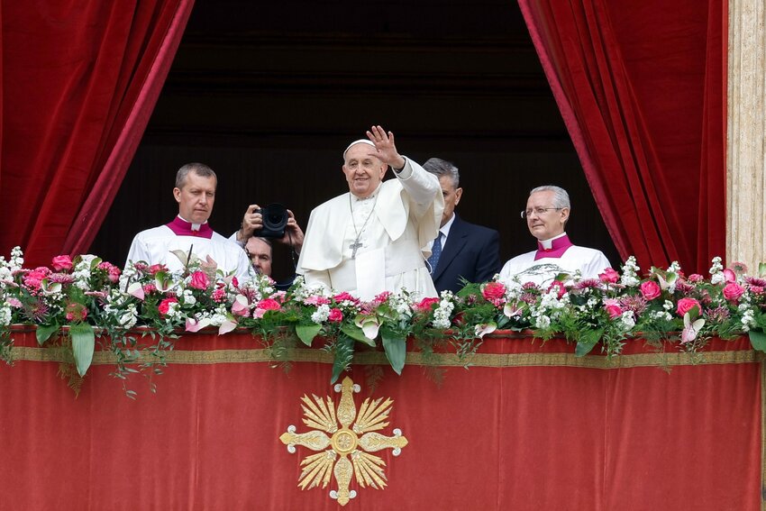 Pope Francis greets the crowd after delivering his Easter message and blessing 