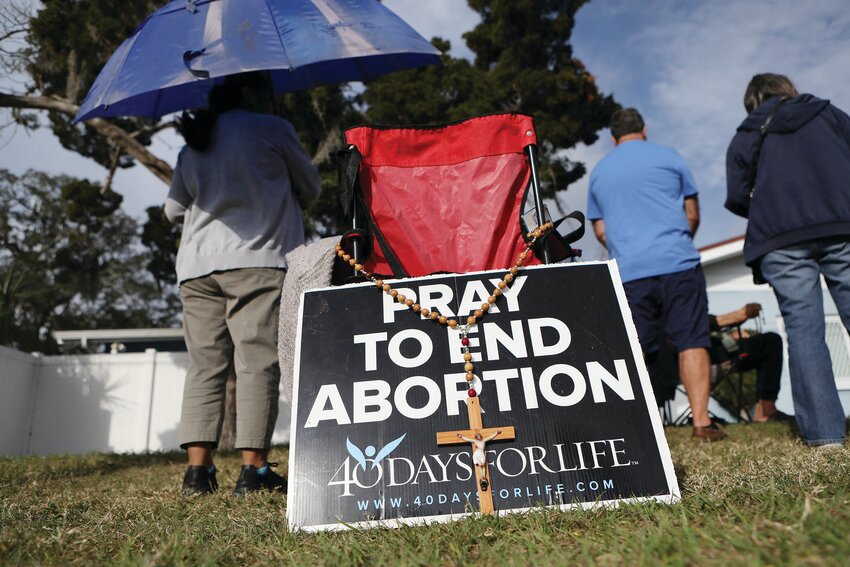 Pro-life activists pray with rosaries as clients arrive at the Bread and Roses Woman's Health Center, a clinic that provides abortions in Clearwater, Fla., Feb. 11, 2023. The Florida Supreme Court on April 1 simultaneously upheld that the state's Constitution does not protect abortion access and allowed a proposed amendment seeking to do so to qualify for the state's November ballot. (OSV News photo/Octavio Jones, Reuters)