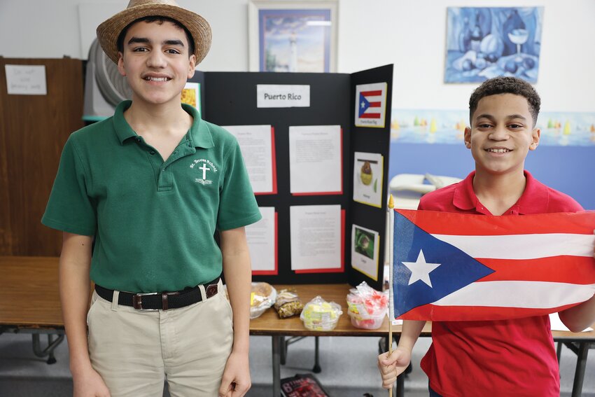 Students at St. Teresa School in Pawtucket enjoy International Night. The evening highlighted various countries chosen by the students who worked to discuss facts about their country, serve their favorite cultural foods, and share the knowledge they learned about their chosen countries with guests.