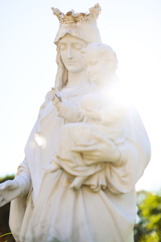 The warm smile of the Blessed Mother holding the infant Jesus greets those at Saint Augustine School and Parish in Providence. May is traditionally dedicated in a special way to honoring Mary and seeking her intercession.