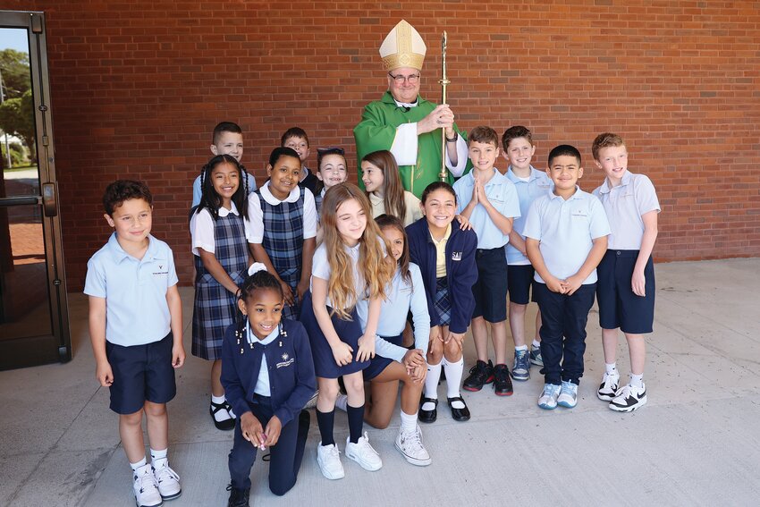 Bishop Richard G. Henning visits with students at Immaculate Conception Catholic Regional School after celebrating Mass in the parish church on May 22.