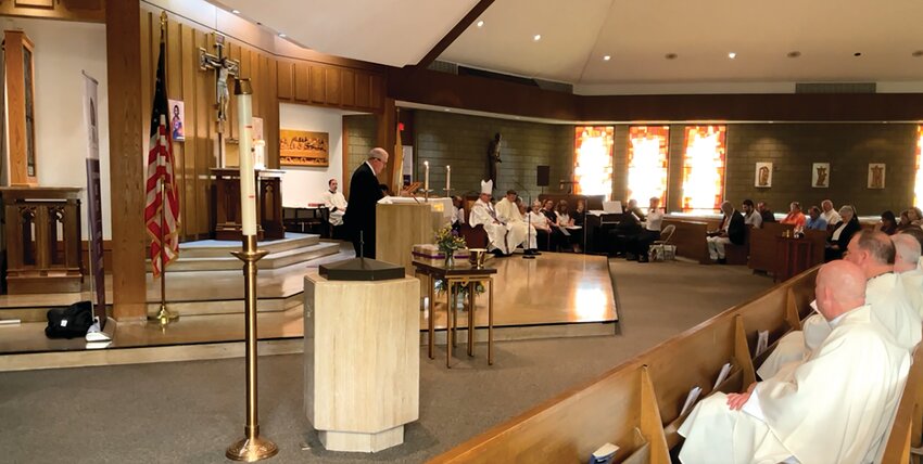 Students, alumni, faculty and staff of St. Raphael Academy gather at Holy Family Parish in Pawtucket to celebrate Mass at the start of celebrations for the 100th anniversary of the founding of the school.