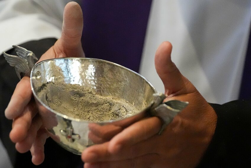 A priest holds a vessel of ashes as Cardinal Angelo De Donatis, head of the Apostolic Penitentiary, celebrates Ash Wednesday Mass at the Basilica of Santa Sabina in Rome March 5, 2025.