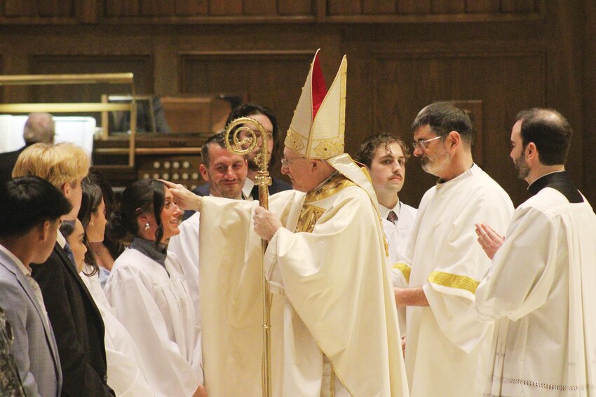 Local faithful gather at the Cathedral of SS. Peter and Paul to celebrate the Easter Vigil Mass presided over by Most Rev. Robert C. Evans.