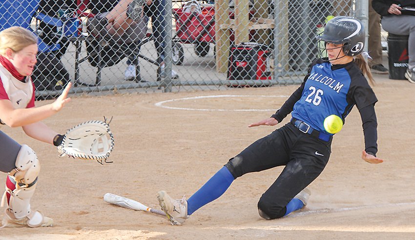 Sidney Holliday of Malcolm slides into home ahead of the throw in Malcolm's win over Fairbury at state softball.