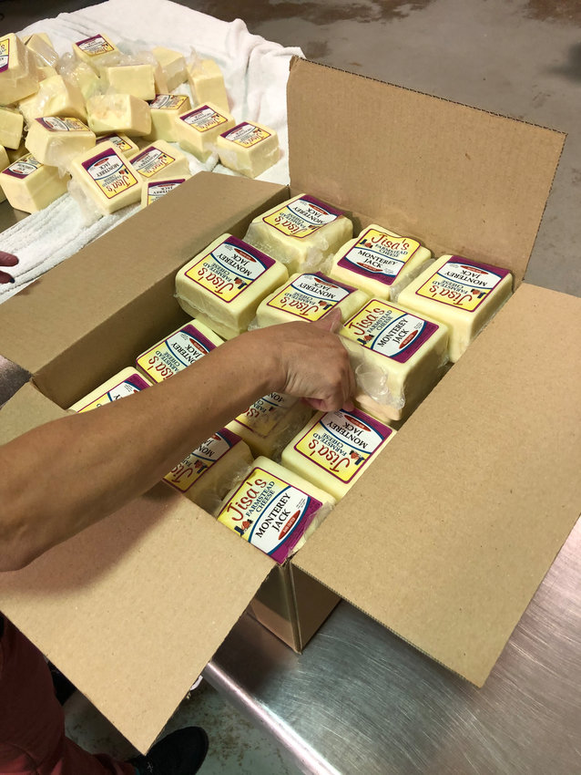 Jisa Cheese is packaged and boxed for distribution, preparing its final step before being sent to local families or groceries.