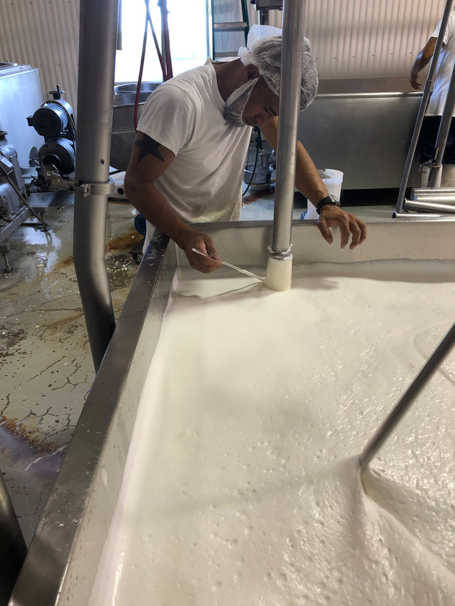 A Jisa Cheese checks machines that stir the dairy's milk before it's formed into cheese.