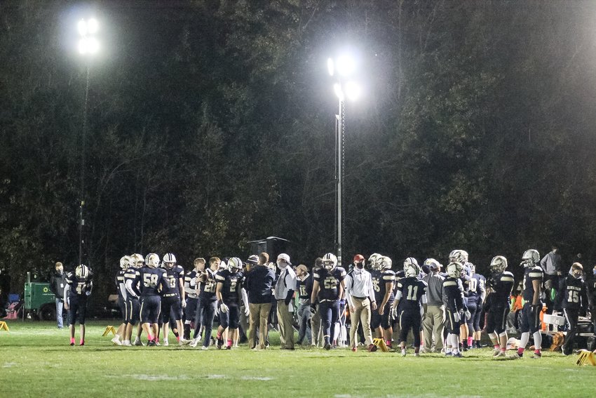 The Lincoln Lutheran football team meets on its sidelines before the second half of the Oct. 16 game against Centennial.