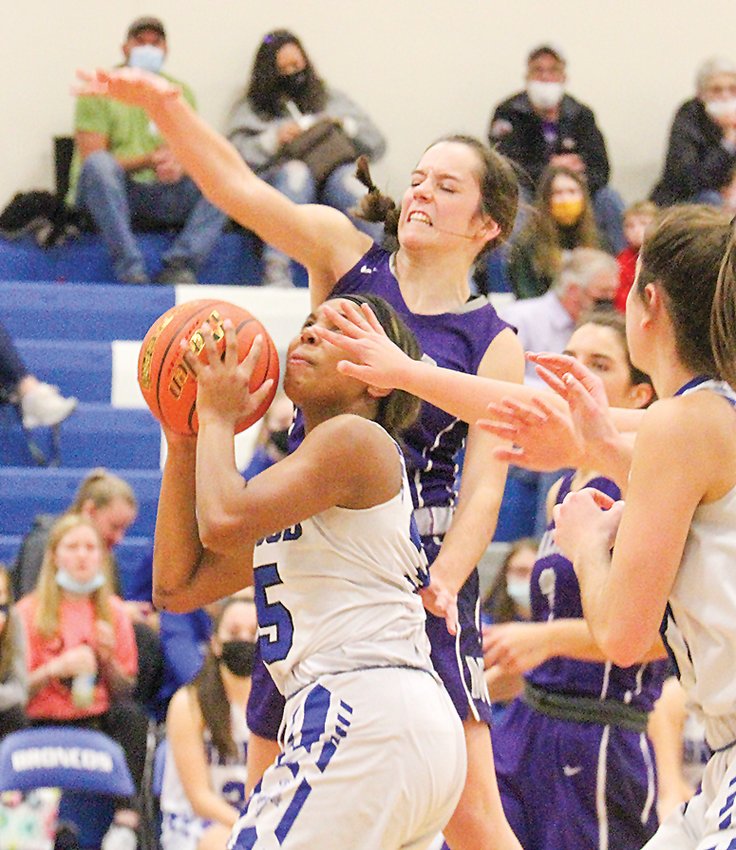 Centennial's Asia Nisly looks for the hoop as Kaitlin Kontor of Milford jumps to block her shot Dec. 18.