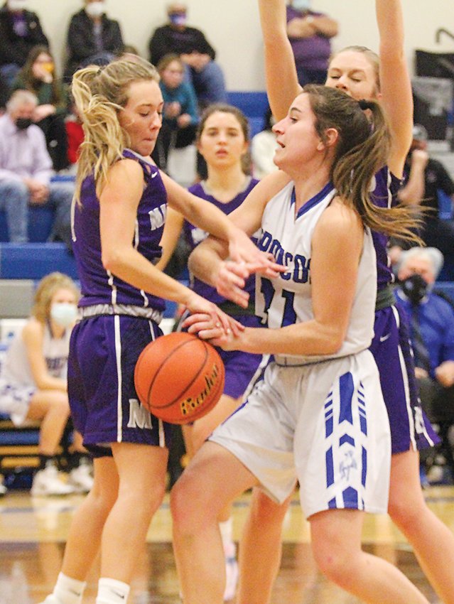 Kiley Rathjen of Centennial turns into the lane and has the ball stolen by Makenna Stutzman of Milford Dec. 18.