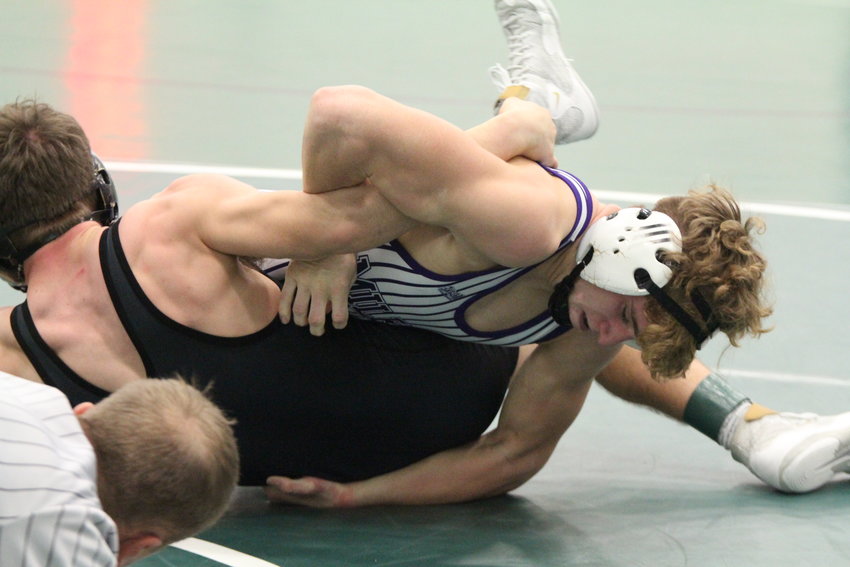 Eli Vondra of Milford tries to tilt Ryan Payne of Centennial for nearfall points during the 132-pound championship match Jan. 30 at the SNC tournament.