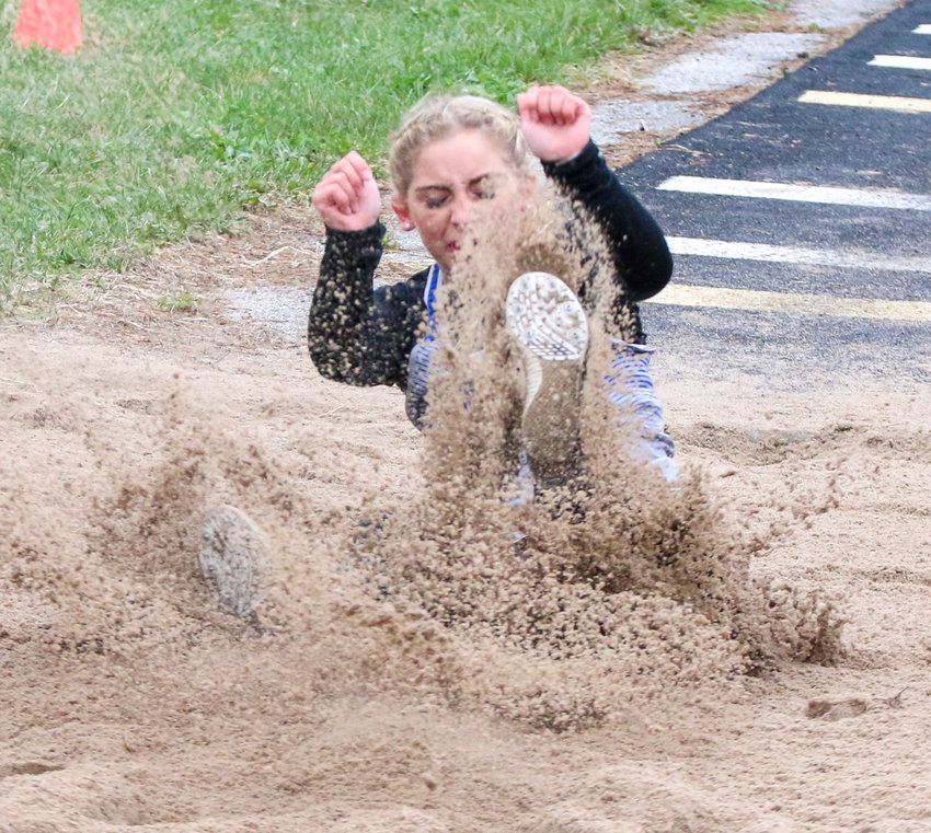 Grace Schleining of Malcolm sticks the landing in the girls' long jump April 7 at Malcolm.