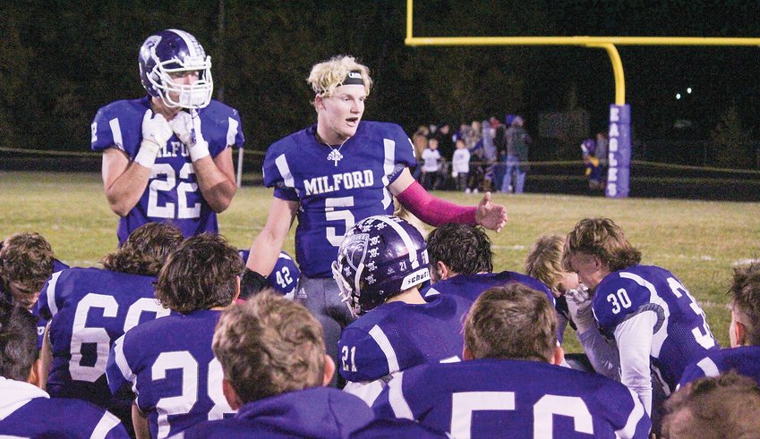 Milford quarterback Jaxon Weyand (5) addresses his teammates after the Eagles' opening round loss to Columbus Lakeview Oct. 29.