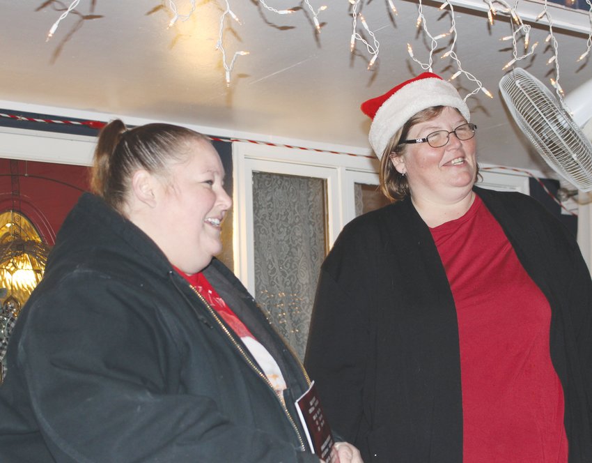 Cati Havens, right, of Milford, was surprised the evening of Dec 20 when friends, led by Kelly Keib, brought a new oven and dishwasher to her home. The act was symbolic of her selfless leadership with the Seward-ish Giving Tree program.